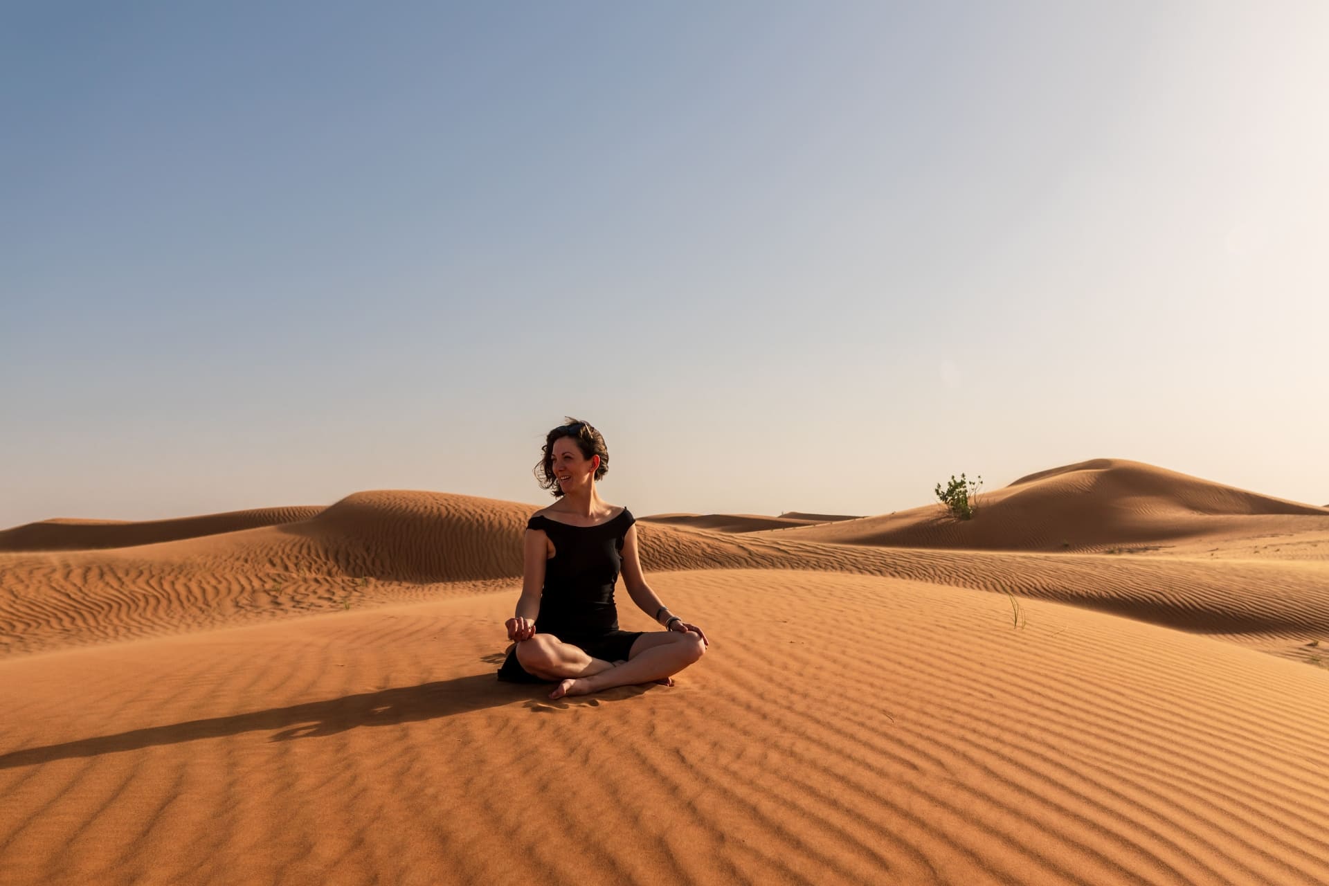 Yoga session in the Sahara desert dunes near Mhamid, Morocco