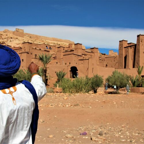 Traveller standing on desert sand near Ouarzazate, Morocco